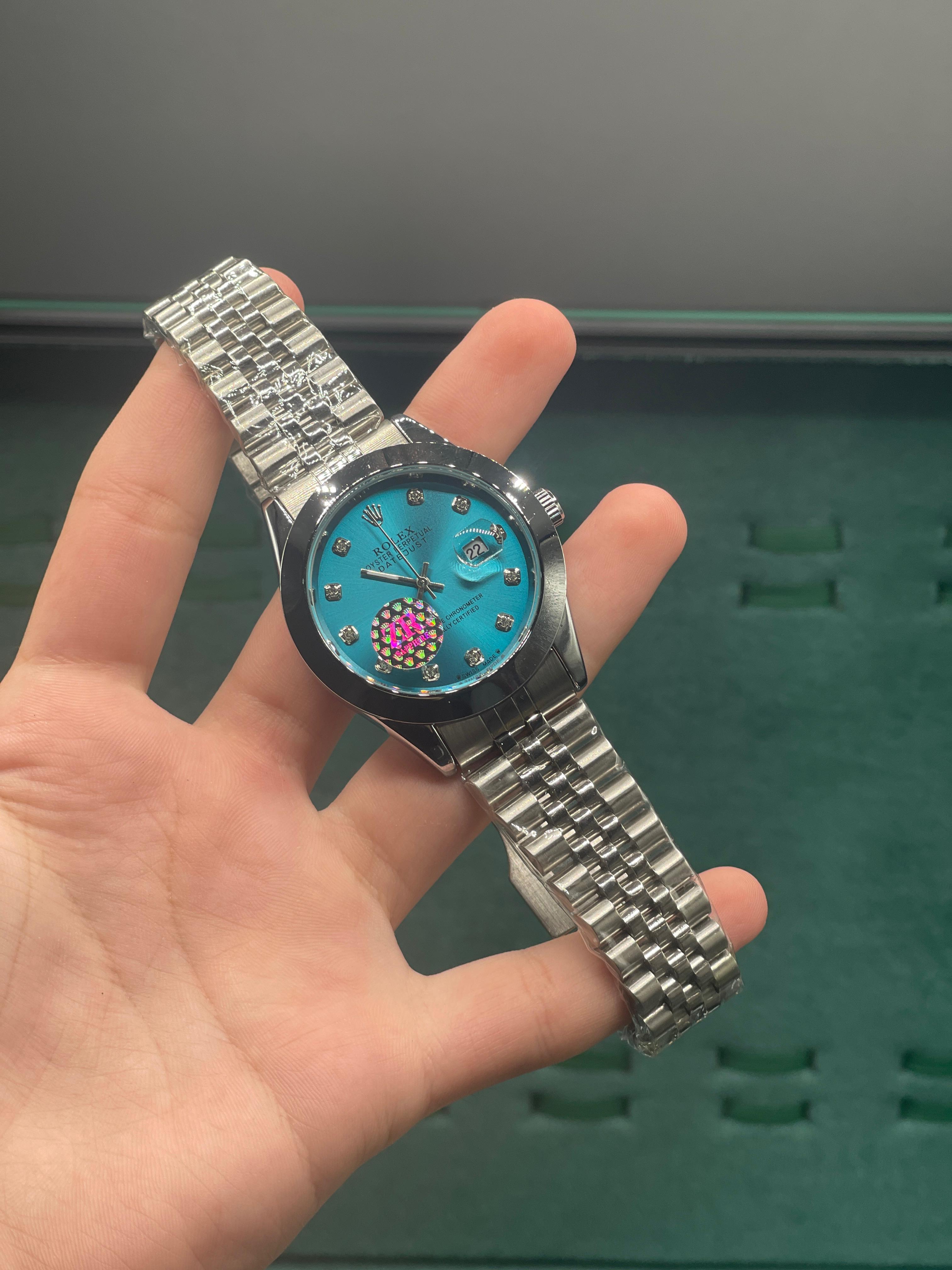 RLX  Stainless Steel Dress Watch with Teal Blue Diamond Dial, Smooth Bezel, and Jubilee Bracelet