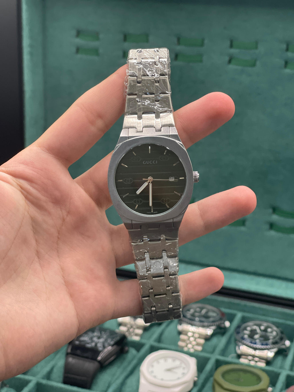 GUCI Stainless Steel Luxury Sports Watch with Black Textured Dial, Integrated Bracelet, and Octagonal Case