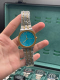 GUCI Two-Tone Luxury Sports Watch with Turquoise Textured Dial, Gold Bezel, and Integrated Bracelet