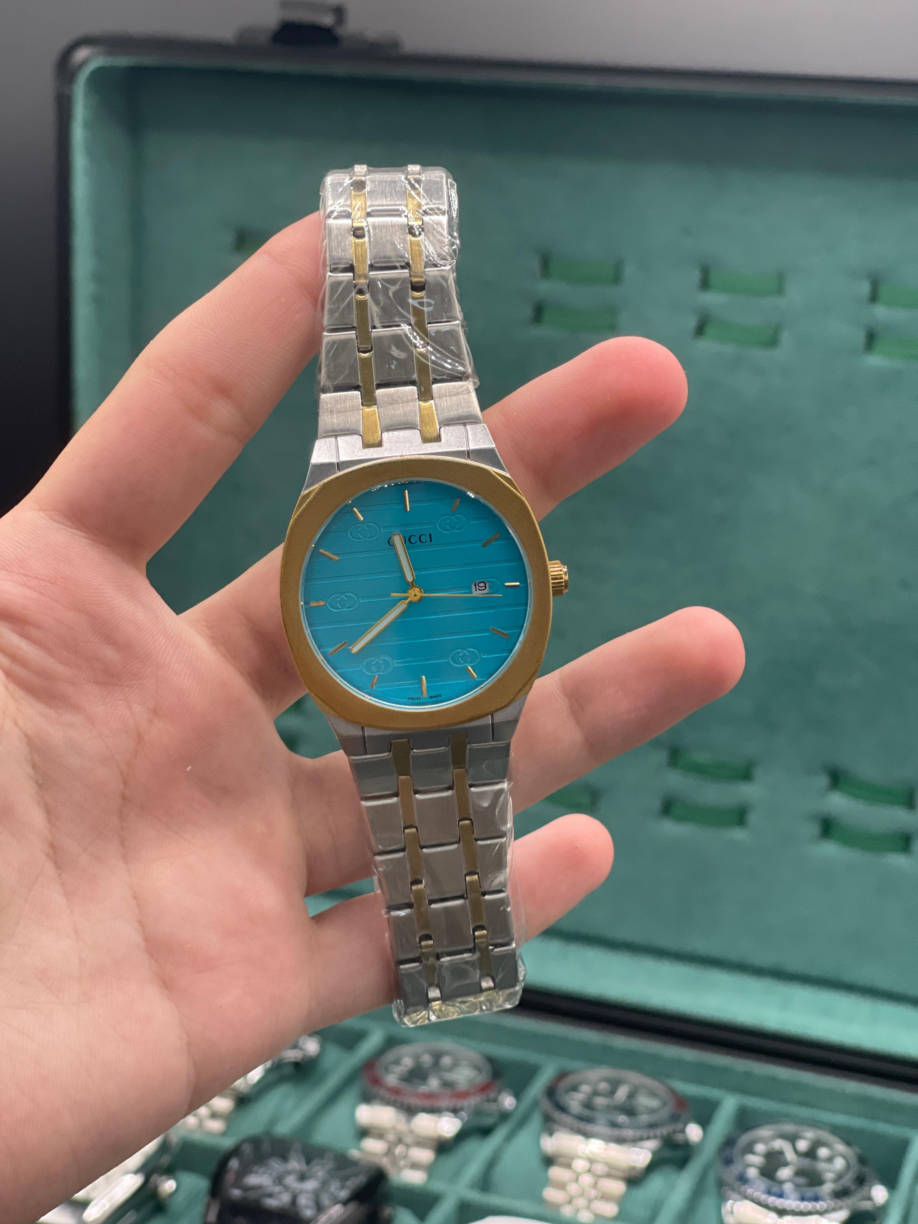 GUCI Two-Tone Luxury Sports Watch with Turquoise Textured Dial, Gold Bezel, and Integrated Bracelet
