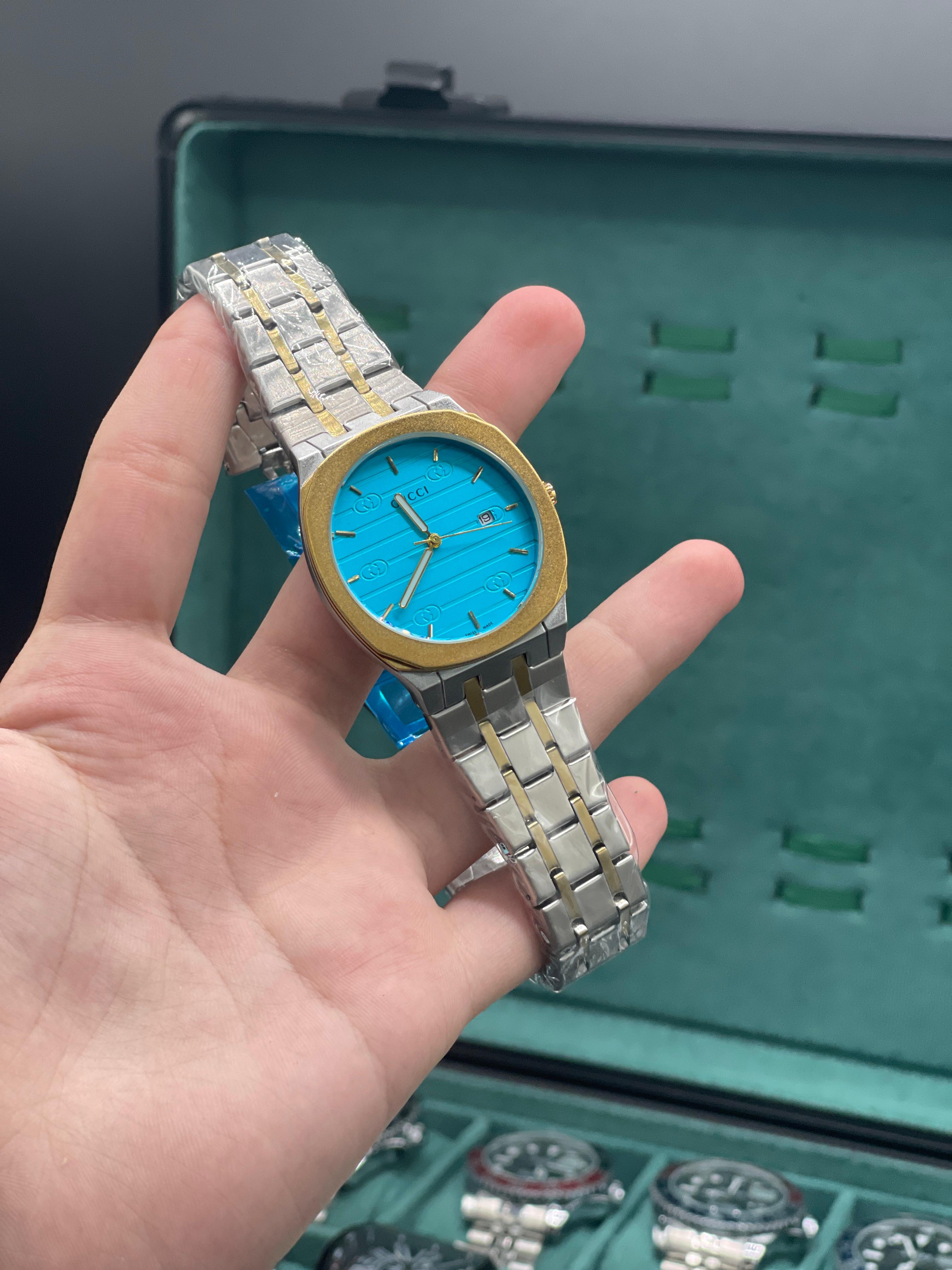 GUCI Two-Tone Luxury Sports Watch with Turquoise Textured Dial, Gold Bezel, and Integrated Bracelet