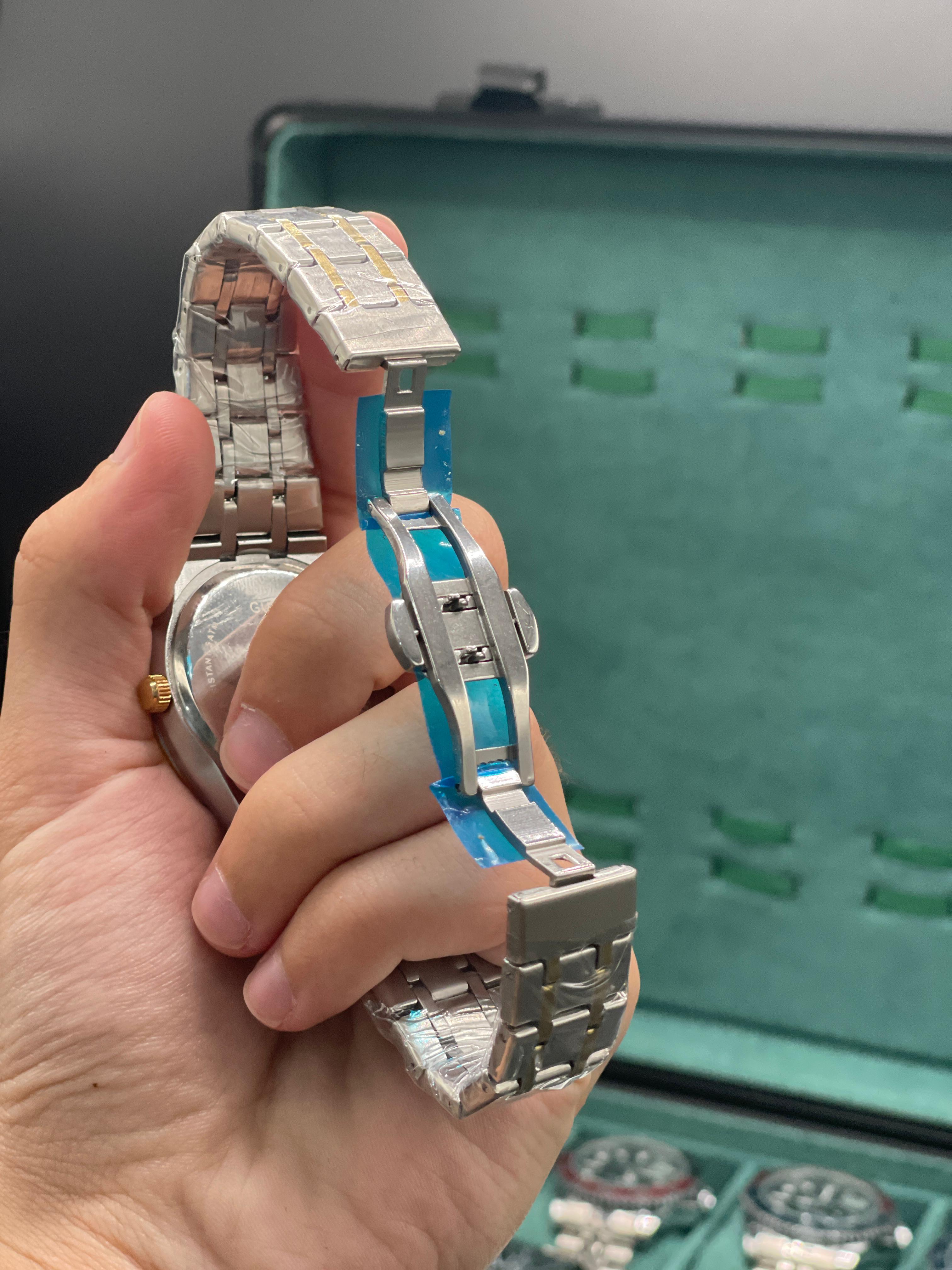GUCI Two-Tone Luxury Sports Watch with Turquoise Textured Dial, Gold Bezel, and Integrated Bracelet
